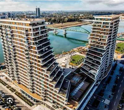 an aerial view of a large apartment building next to a river at BW Residences - Belgrade Waterfront in Sajmište