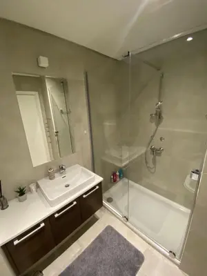 a bathroom with a shower and a sink and a glass shower stall at BW Residences - Belgrade Waterfront in Sajmište