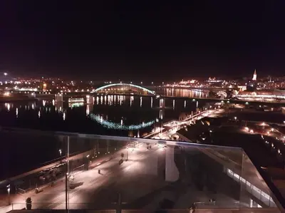 a view of a city at night with a bridge at BW Residences - Belgrade Waterfront in Sajmište