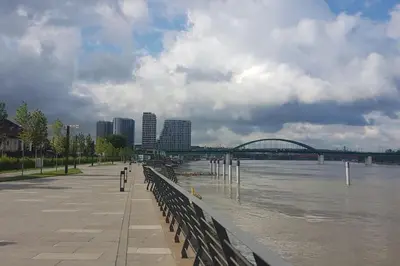 a view of a river with a bridge and buildings at BW Residences - Belgrade Waterfront in Sajmište