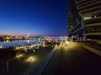 a view of a city at night with a building at BW Residences - Belgrade Waterfront in Sajmište