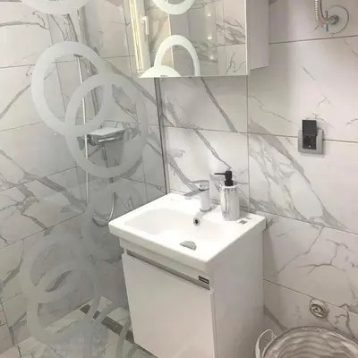 a white bathroom with a sink and a mirror at Apartman Vojvoda in Sajmište