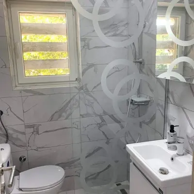 a bathroom with a white toilet and a sink at Apartman Vojvoda in Sajmište