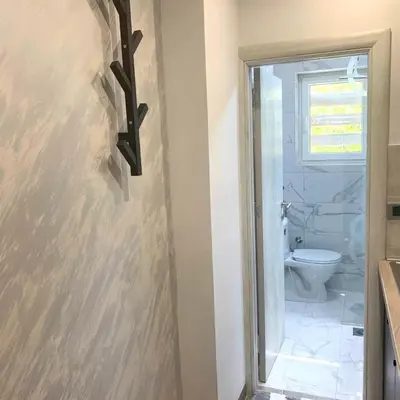 a bathroom with a white toilet and a sink at Apartman Vojvoda in Sajmište