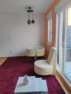 a living room with a glass table and a white chair at Apartment Stevanovic Belgrade in Vračar (historical)