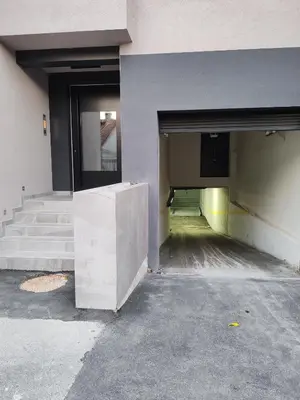 a building with two doors and stairs in a parking lot at Apartment Stevanovic Belgrade in Vračar (historical)