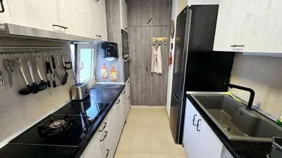 a small kitchen with a sink and a refrigerator at Apartment 10 in Belgrade
