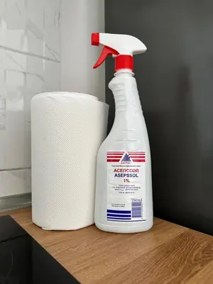 a bottle of disinfectant next to a roll of toilet paper at Apartment BLOK62 in Bežanija