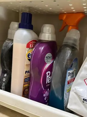 four bottles of cleaning products are sitting on a shelf in a refrigerator at Apartment BLOK62 in Bežanija