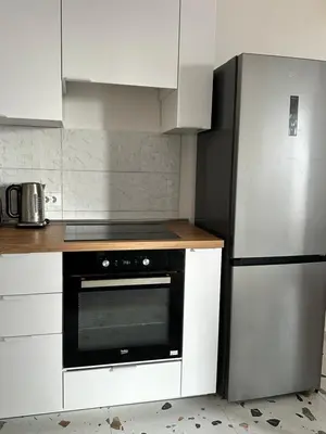 a kitchen with a stove and a refrigerator at Apartment BLOK62 in Bežanija