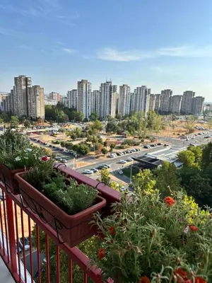 a balcony with some plants on a city street at Apartment BLOK62 in Bežanija
