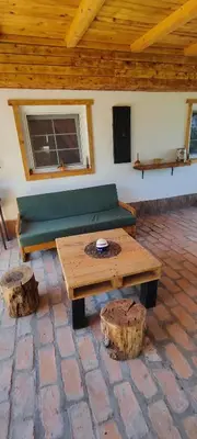 a living room with a green couch and a coffee table at Mali Raj in Beška