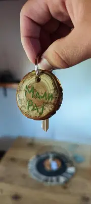 a person holding a small keychain with handwriting on it at Mali Raj in Beška