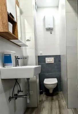 a bathroom with a sink and a toilet at Apartment Square 59 Belgrade center in Belgrade