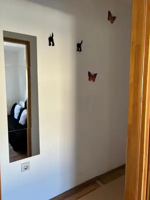 a room with butterflies on the wall and a mirror at Kneginje Ljubice Apartment in Belgrade