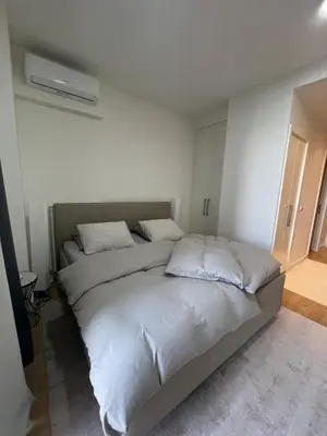 a bedroom with a large bed with white sheets at Belgrade Waterfront - Verde Studio in Sajmište