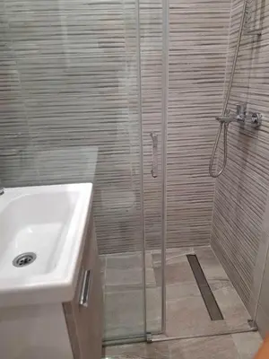 a shower with a glass door next to a sink at Arena New Belgrade by Magenta in Novi Beograd