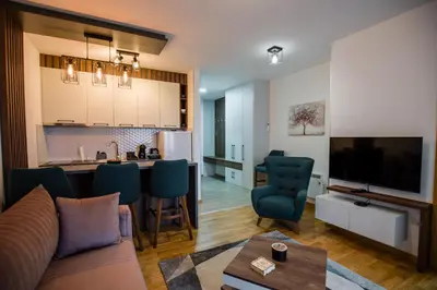 a living room with a couch and a kitchen at TOP VIEW apartment 39 in Arandjelovac