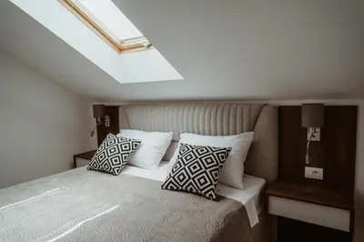 a bedroom with a bed with two pillows on it at TOP VIEW apartment 39 in Arandjelovac