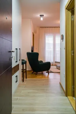 a living room with a black chair and a window at TOP VIEW apartment 39 in Arandjelovac