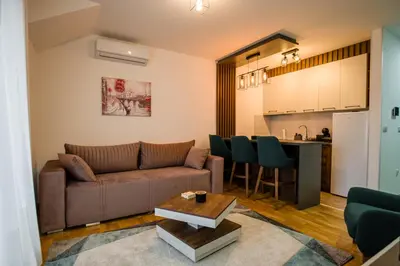 a living room with a couch and a kitchen at TOP VIEW apartment 39 in Arandjelovac