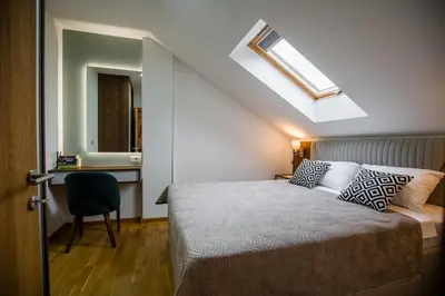 a bedroom with a bed and a desk and a skylight at TOP VIEW apartment 39 in Arandjelovac