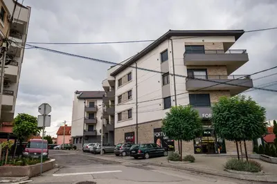 an apartment building on a street with parked cars at TOP VIEW apartment 39 in Arandjelovac