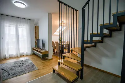 a living room with stairs and a dining room at TOP VIEW apartment 44 in Arandjelovac