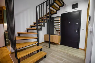 a staircase in a house with a black door at TOP VIEW apartment 44 in Arandjelovac