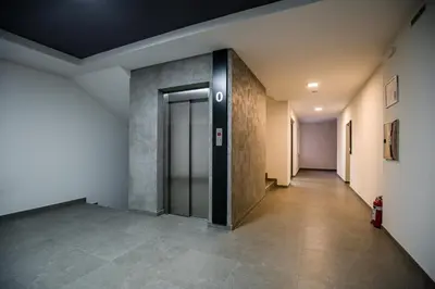 a hallway of an office building with a door at TOP VIEW apartment 44 in Arandjelovac