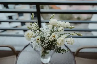 a vase filled with white flowers on a table at TOP VIEW apartment 46 in Arandjelovac