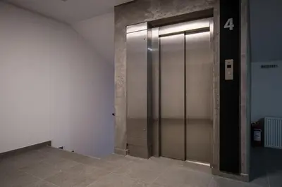 a elevator in a building with the number four at TOP VIEW apartment 46 in Arandjelovac