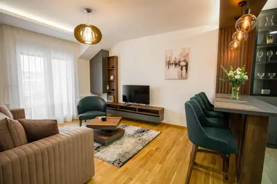 a living room with a couch and chairs and a television at TOP VIEW apartment 47 in Arandjelovac
