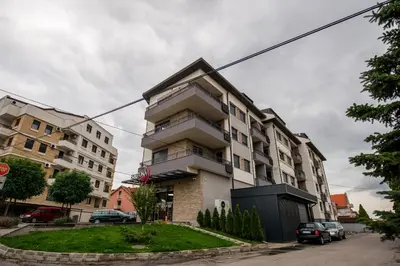 a building on a street with cars parked in front of it at TOP VIEW apartment 47 in Arandjelovac