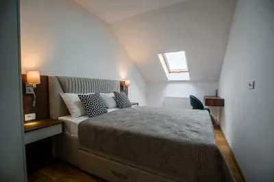a bedroom with a bed and a couch at TOP VIEW apartment 47 in Arandjelovac