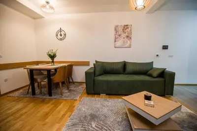 a living room with a green couch and a table at TOP VIEW apartment 40 in Arandjelovac