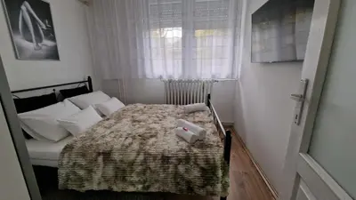 a bedroom with a bed with two towels on it at Fontana in Belgrade