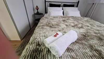 a bed with two white towels on top of it at Fontana in Belgrade