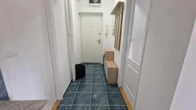 a hallway with a door and a tile floor at Fontana in Belgrade