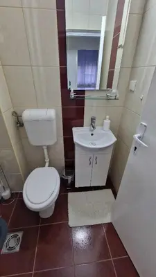a small bathroom with a toilet and a sink at Fontana in Belgrade