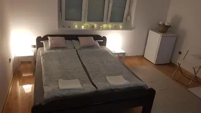 a bedroom with a bed with two pillows on it at Apartman Vojvoda 1 in Sajmište