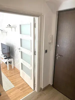 an open door to a room with a television at Apartman Vojvoda 1 in Sajmište