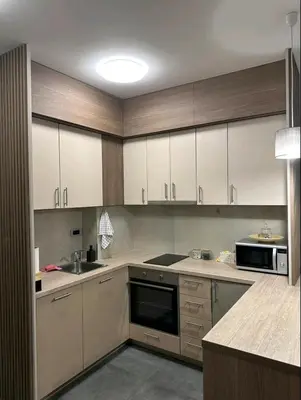 a large kitchen with white cabinets and a sink at Dreams Hill Studio in Čukarica