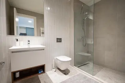 a bathroom with a shower and a toilet and a sink at Belgrade Waterfront Apartments - Libera in Belgrade