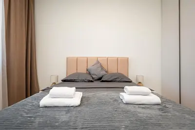 a bed with two towels on top of it at Belgrade Waterfront Apartments - Libera in Belgrade