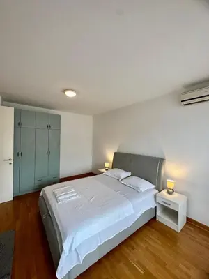 a bedroom with a large white bed and two lamps at Bellvil 55 in Belgrade