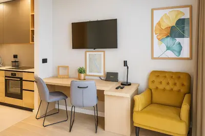a kitchen with a desk with a chair and a computer at Waterfront Cosy Studio Nest in Sajmište
