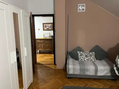 a hallway with a couch with a pillow on it at Apartman 1 in Krnjača