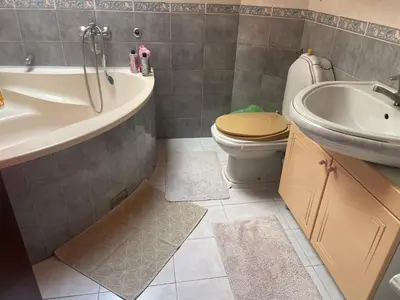 a bathroom with a tub and a toilet and a sink at Apartman 1 in Krnjača