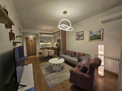 a living room with a couch and a table at BwMils Apartment in Belgrade